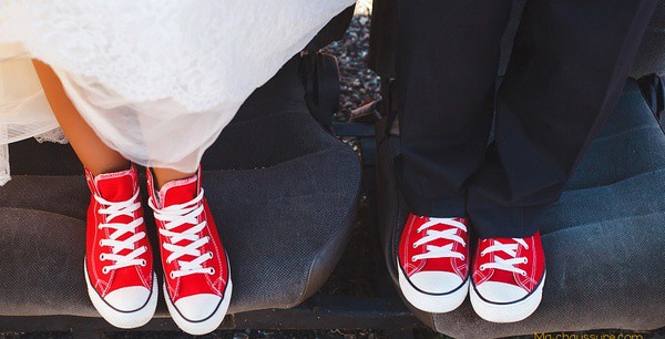 Couple portant des baskets de mariage rouges